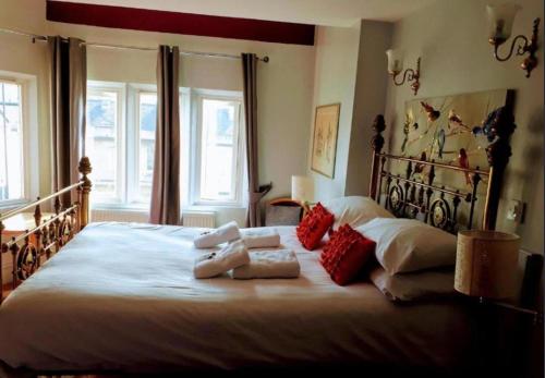 a bedroom with a large white bed with red pillows at En-suite Double Room in Bath