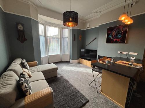 een woonkamer met een bank en een tafel bij Shannon suite in Southport