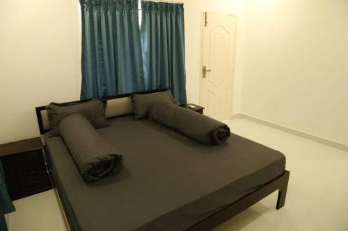a bed with two pillows on it in a bedroom at T Nagar 1BHK Studio Shopping Cntrl - G3 Tulsi in Chennai