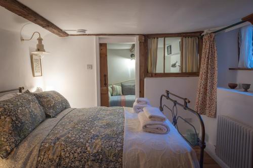 a bedroom with a bed with towels on it at The Old Scullery in Bungay