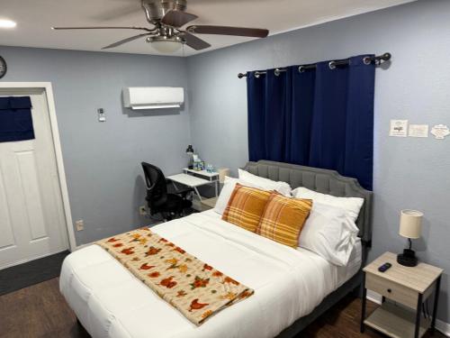 a bedroom with a bed and a desk in it at Signature Suite in Orlando