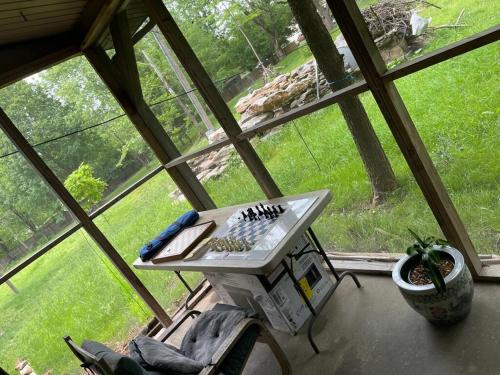 a table in a room with a large window at Peaceful Resort Retreat in Springfield