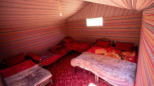 a room with two beds in a tent at Sunrise Magic Camp in Wadi Rum