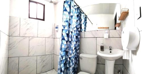 a small bathroom with a toilet and a sink at Casa Chika Playa Grande Guanacaste 3 in Cuajiniquil