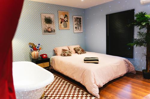 a bedroom with a bed in a room with blue walls at My Funky House - Jacuzzi, Sauna, billard, cinéma, Nintendo Switch, jeux, filet suspendu in Manage