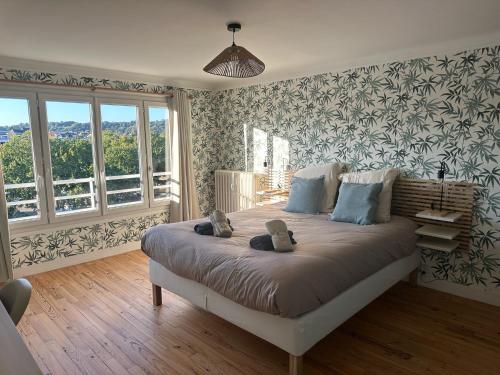 Un dormitorio con una cama con dos ositos de peluche encima. en Beaux-Regards, en Saint Lo