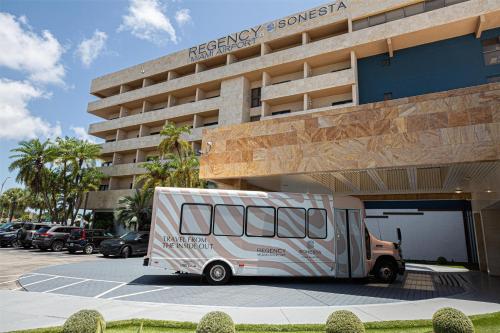 a truck parked in a parking lot in front of a building at Regency Miami Airport by Sonesta in Miami