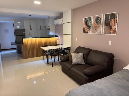 a living room and kitchen with a couch and a table at Loft Com Vista Para O Mar in Arraial do Cabo
