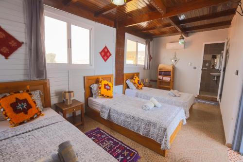 a bedroom with three beds in a room at Blue Rina Hostel in Agadir