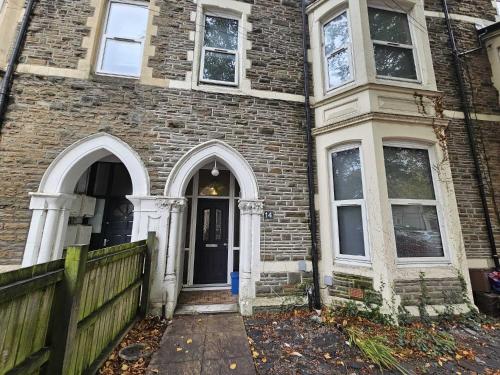 an old brick house with a door and windows at CityPad 2BR City Centre Modern Apartment with Parking in Cardiff