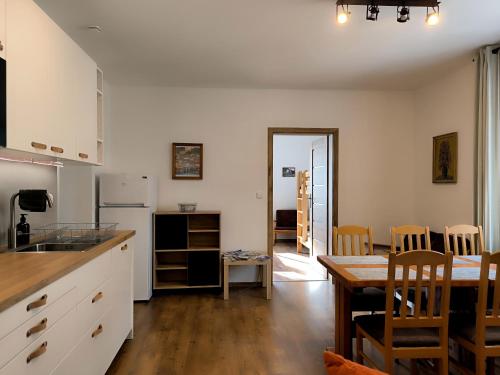 a kitchen with a table and a dining room at Apartmány Pekárna in Staré Město