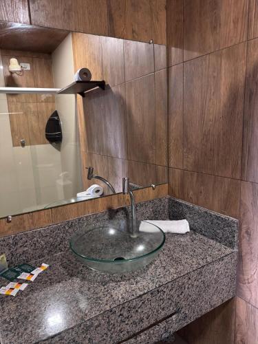 a bathroom counter with a sink and a mirror at Pousada Solare in Maragogi
