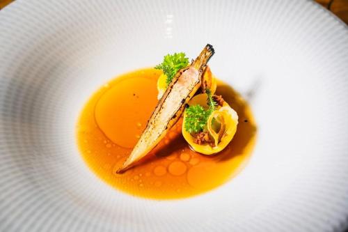 a plate of food with an egg and fish on it at Design Hotel & Restaurant Löwen in Ulm