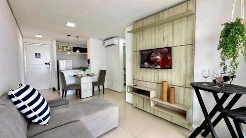 a living room and kitchen with a couch and a table at (1001) Vista Mar Perto das Praias in Vinhais