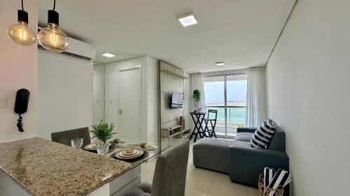 a kitchen and living room with a couch and a table at (1001) Vista Mar Perto das Praias in Vinhais