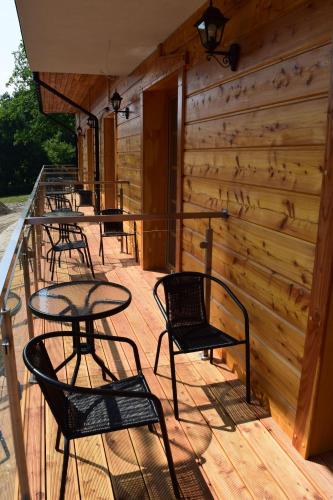 a group of chairs and tables on a deck at Pensjonat Karczma Spalska in Spała