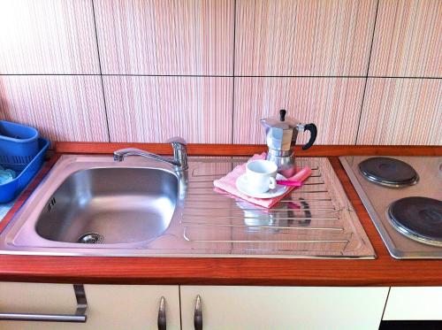 a kitchen counter with a sink and a coffee maker at Apartments Luna in Lovran