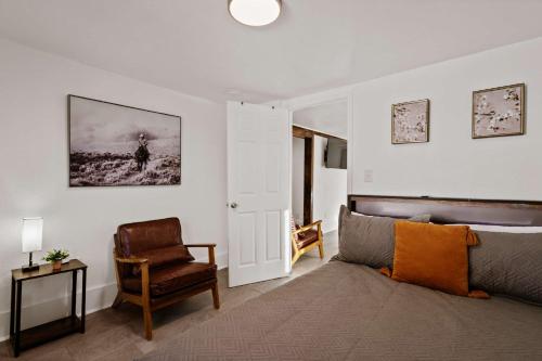 a bedroom with a bed and a chair at Blue Ox in Pensacola