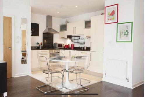 a kitchen with a table and chairs in a room at Lovely Duplex close to city and Guinness Factory in Dublin