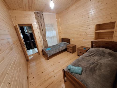 an overhead view of a bedroom in a log cabin at Heshklar guest house in Keshkili