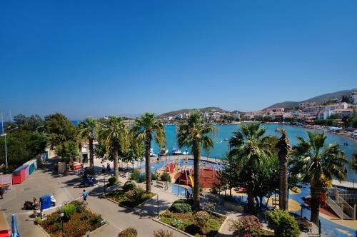 a view of a city with palm trees and a body of water at Fora Apart Hotel in Datca