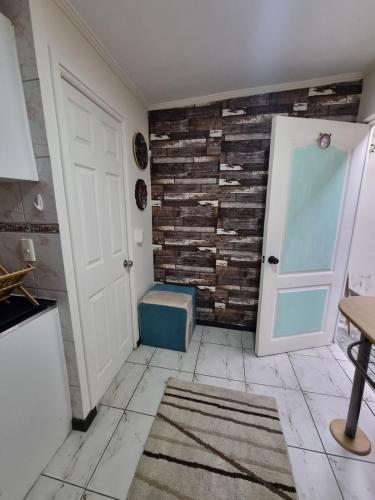 a room with a door and a brick wall at El chalet del Gato, Loft en hermoso barrio central Viña del Mar in Viña del Mar