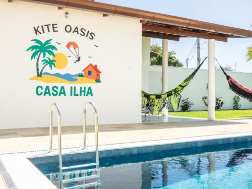 a resort with a swimming pool and a sign that reads kite oasis las at Kite Oasis Parajuru Casa Ilha in Parajuru