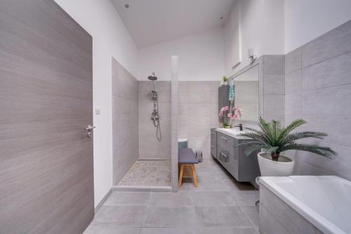 a bathroom with a tub and a sink and a toilet at Gîte des Coteaux - Family home with pool in Saint-Aignan