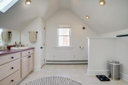 a white bathroom with a sink and a window at Walk to Marina, Park and Dtwn Cambridge Family Home in Cambridge