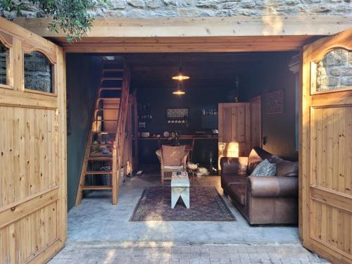 a living room with a couch and a table at Stone Cottage With Sea Views in Wilderness