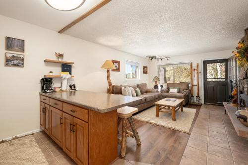 a kitchen and living room with a couch at Hi Country Haus Unit 1515 in Winter Park