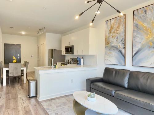 a living room with a couch and a kitchen at Modern 1-Bedroom Condo in Downtown Atlanta 525Pkwy517 in Atlanta