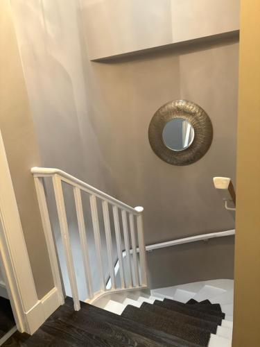 a mirror on a wall next to a staircase at The Close in Kelso