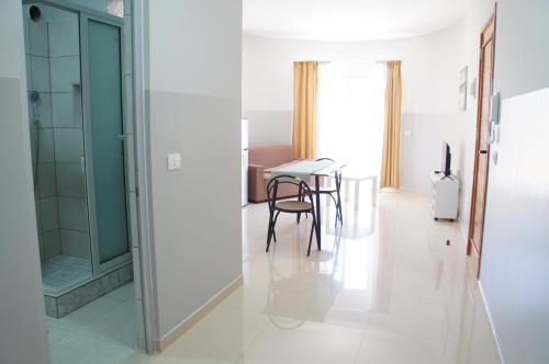 a room with a table and a glass door at Ilidia Guest House in Sal Rei