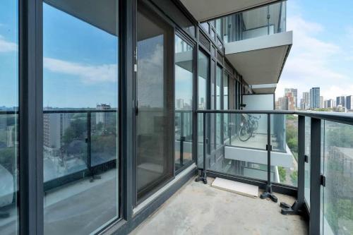 an empty balcony with glass windows in a building at City Lights Studio w Balcony Walk to Eaton Centre in Toronto