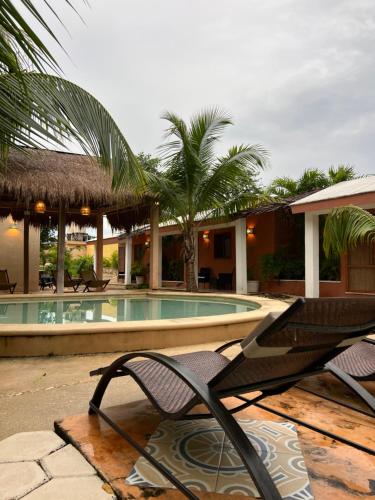 a resort with a chair and a swimming pool at CASA VICTORIA in Chichén-Itzá