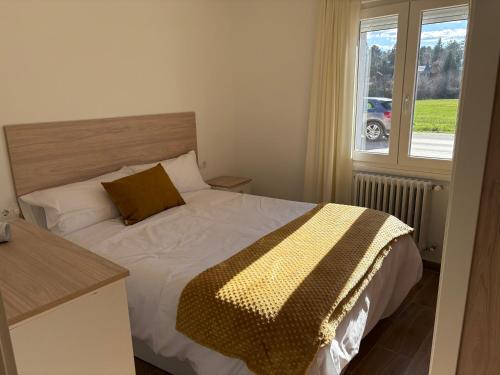 a bedroom with a bed and a window at El pisito de Cris y Mia in Ponferrada