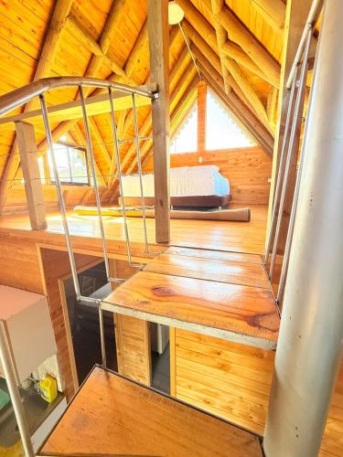 a wooden staircase in a room with a wooden ceiling at Glamping en Rionegro in Rionegro