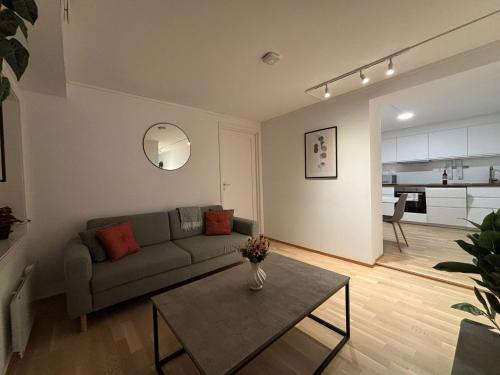 a living room with a couch and a table at Cozy Aurora View Apartments - Entire 3-Bedroom Fully Furnished Near City Centre in Tromsø