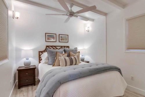 a bedroom with a bed with a ceiling fan at Jetty View 1 in San Diego