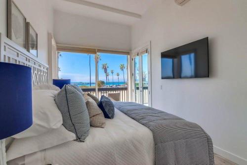 a bedroom with a large bed and a television at Jetty View 2 in San Diego