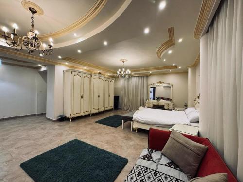 a large bedroom with a bed and a couch at beverly villa in Sheikh Zayed