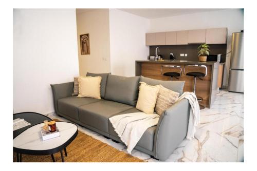 a living room with a couch and a table at Exclusive Corner Penthouse with Terrace - by HostMT in St. Paul's Bay
