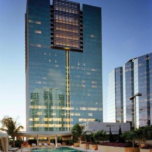 a tall building with a pool in front of it at Brickell Arch Residences Free Parking by Palermo Home Miami in Miami