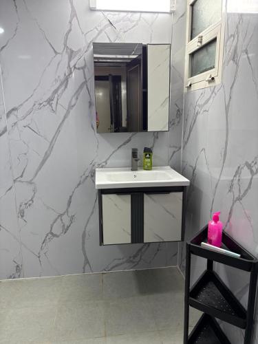 a bathroom with a sink and a mirror at Studio in Ajman Corniche in Ajman 