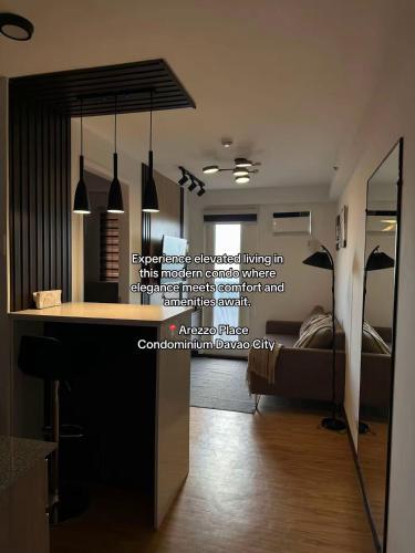 a bedroom with a bed and a desk in a room at D'living Condotel in Davao City