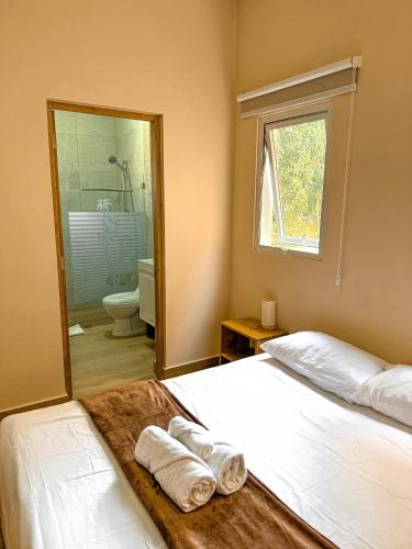 a bedroom with a bed with towels on it at Gipsy Ranch Rooms in Cabarete