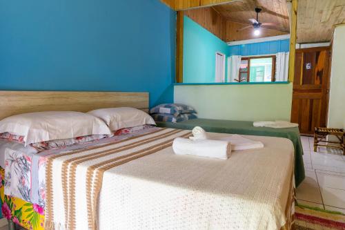 a bedroom with a bed with towels on it at Pousada Canto da Sereia in Ilha do Mel