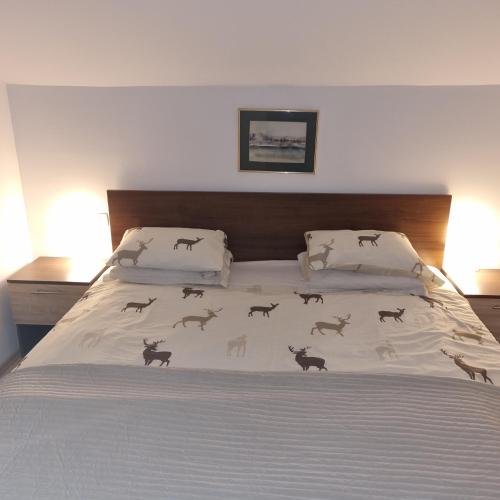 a bedroom with a bed with animals on the bedspread at Rupicapra Holiday Mountain House in Kostel