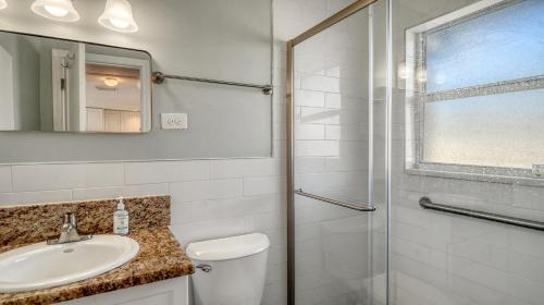 a white bathroom with a sink and a shower at Jamaica Royale #40 - 3 Heated Pools on the Beach! in Siesta Key